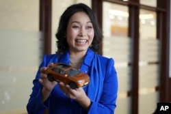 Vinfast CEO Le Thi Thu Thuy holds up a miniature model of a Vinfast car in Hanoi, Vietnam, on Sept. 29, 2023.