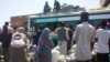 People board a bus to leave Khartoum, June 3, 2023, as fighting between the Sudanese Army and paramilitary Rapid Support Forces intensified. 