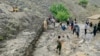 Residents shovel mud following flash floods after heavy rainfall at Pesgaran village in Afghanistan's Panjshir province on July 15, 2024. At least 35 people were killed and 230 injured after heavy rain in eastern Afghanistan, a local official said.