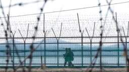 South Korean army soldiers patrol along the barbed-wire fence in Paju, South Korea, near the border with North Korea, Feb. 16, 2023. 