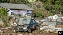 Damaged vehicles are seen in a cemetery after an extratropical cyclone hit southern Brazil, in Caraa, Rio Grande do Sul state, June 18, 2023.
