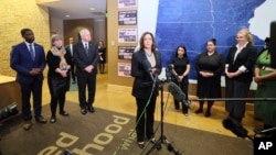 From left, St. Paul Mayor Melvin Carter, U.S. Rep. Betty McCullum, D-Minn., and Minnesota Gov. Tim Walz listen as Vice President Kamala Harris speaks at Planned Parenthood, March 14, 2024, in St. Paul, Minn.