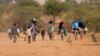 Sudanese families fleeing the conflict in Sudan's Darfur region, make their way through the desert after they crossed the border between Sudan and Chad to seek refuge in Goungour, Chad May 12, 2023.