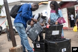 Election officials prepare to dispatch electoral kits ahead of the presidential elections, in Kinshasa, Democratic Republic of the Congo, Dec. 19, 2023.