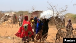 FILE - Somali refugees walk outside their makeshift shelters in the new arrivals area at the Hagadera refugee camp in Dadaab, near the Kenya-Somalia border, in Garissa County, Kenya, Jan. 17, 2023. 