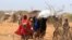 FILE - Somali refugees walk outside their makeshift shelters in the new arrivals area at the Hagadera refugee camp in Dadaab, near the Kenya-Somalia border, in Garissa County, Kenya, Jan. 17, 2023. 