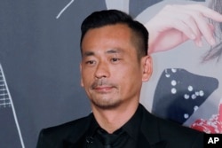 FILE - Suncity Group CEO Alvin Chau poses on the red carpet of the Hong Kong Film Awards in Hong Kong, April 15, 2018.