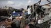 FILE - Displaced Palestinians inspect their tents destroyed by Israel's bombardment, adjunct to an UNRWA facility west of Rafah city, Gaza Strip, May 28, 2024.