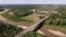 FILE - The Integration border bridge connects Assis, Brazil, left, and Inapari, Peru, June 20, 2024. Brazil will begin imposing restrictions on the entry of some foreigners from Asia who use Brazil as a launching point to migrate to the United States and Canada.