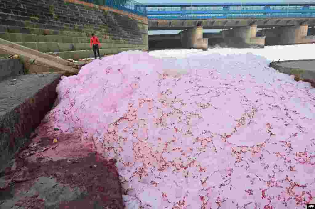 A man looks at the polluted river Yamuna in New Delhi, India.