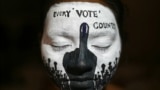 A college student has her face painted to spread awareness for first generation voters during an election campaign ahead of India's upcoming national elections in Chennai, India, March 19, 2024.