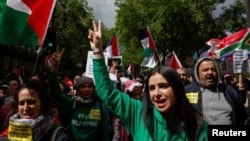 People gather in Paris to take a stand against racism, Islamophobia and violence against children, April 21, 2024. Some participants wore shirts that said "Free Palestine."