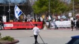 A counter-protester holding an Israeli flag walks into the parking lot near a protest at Google Cloud offices in Sunnyvale, California, April 16, 2024.