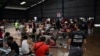 FILE - Migrants from Venezuela wait for transportation to continue on their way north to Nicaragua and hopefully to the Mexico-United States border, at a Migrant Temporal Attention Center in Costa Rica, Oct. 16, 2023. 