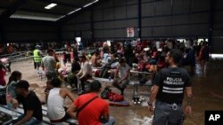 FILE - Migrants from Venezuela wait for transportation to continue on their way north to Nicaragua and hopefully to the Mexico-United States border, at a Migrant Temporal Attention Center in Costa Rica, Oct. 16, 2023. 
