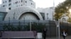 A plainclothes security person stands watch outside the Israeli Embassy in Beijing, Oct. 13, 2023. 