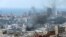 FILE - Smoke rises from Ein el-Hilweh Palestinian refugee camp during a previous round of Palestinian factional clashes, in Sidon, Lebanon, July 30, 2023.