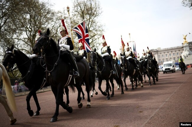 The Household Cavalry rides down the Mall outside Buckingham Palace ahead of the Coronation of Britain's King Charles and Camilla, Queen Consort, in London, May 4, 2023.
