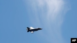 FILE - A fighter jet flies over Washington, June 12, 2019. Military planes were scrambled Sunday over the U.S. capital after a light aircraft violated its airspace and later crashed in southwestern Virginia.