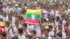 (FILE) Rohingya refugees gather in the raint o demand safe return to Myanmar's Rakhine state as they mark the seventh anniversary of their exodus at their refugee camp in Cox's Bazar district, Bangladesh, Aug. 25, 2024. 