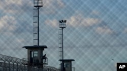 A prison guard sits in a watchtower at the Pinero jail in Pinero, Argentina, April 9, 2024.