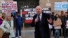 British lawmaker Iain Duncan Smith and human rights campaigner Helena Kennedy, left, join activists and community members as they protest outside the British Foreign Office in central London, Feb. 13, 2023. 