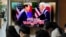 A TV screen shows an image of US President Joe Biden and South Korean President Yoon Suk Yeol in Washington, during a news program at the Seoul Railway Station in Seoul, South Korea, April 27, 2023. 