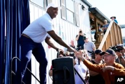 FILE - Republican presidential candidate Sen. Tim Scott, R-S.C., greets audience members before speaking at the Iowa State Fair, in Des Moines, Iowa, Aug. 15, 2023.