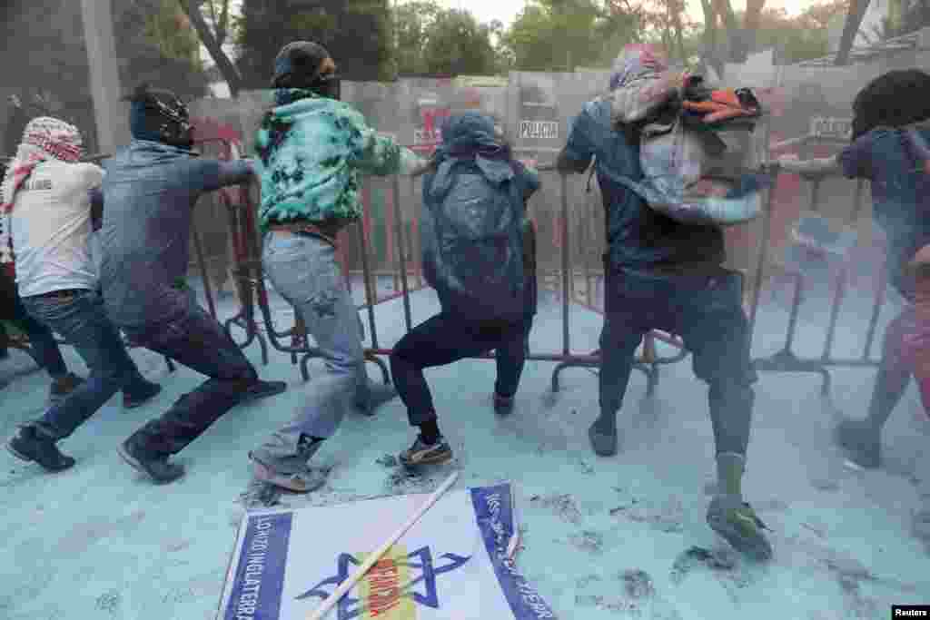 Demonstrators pull a fence during a protest in support of Palestinians outside the Israel Embassy, amid the ongoing conflict between Israel and Hamas, in Mexico City, Mexico, May 28, 2024.