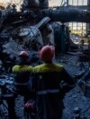 Workers stand among debris in a damaged DTEK thermal power plant after a Russian attack in Ukraine, May 2, 2024.