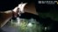 FILE - In this image taken from body camera video released June 22, 2023, by U.S. Customs and Border Protection, an agent points a gun at tribal member Raymond Mattia, May 19, in Tohono O'odham Nation, in southern Arizona.