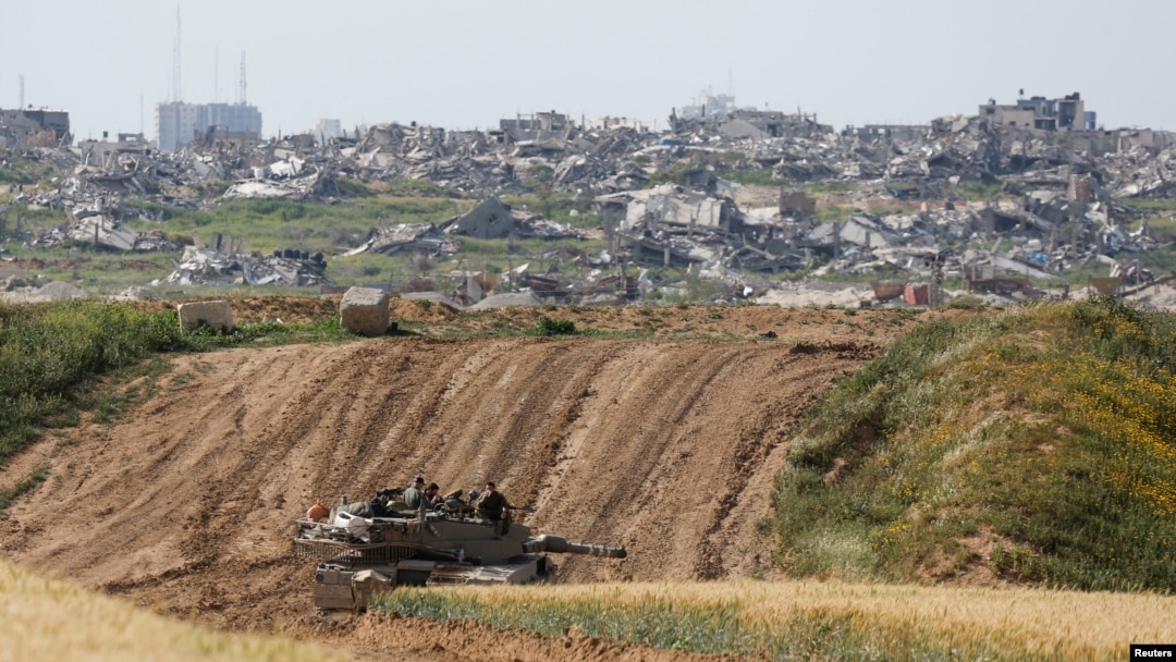 An Israeli tank holds a position, amid the ongoing conflict between Israel and the Palestinian Islamist group Hamas, near the Israel-Gaza border, in Israel, March 26, 2024.