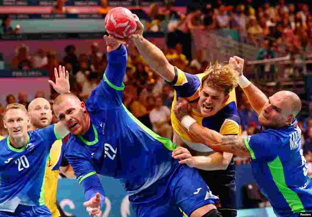 Matej Gaber of Slovenia, Karl Wallinius of Sweden and Borut Mackovsek of Slovenia attempt to score a goal&nbsp;during the men&#39;s handball preliminary round group A match at the South Paris Arena 6 in Paris, France, at the Paris Olympics.&nbsp;