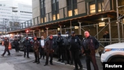 Police officers gather outside Manhattan Criminal Court after former President Donald Trump's indictment by a Manhattan grand jury following a probe into hush money paid to Stormy Daniels, in New York, March 30, 2023. 
