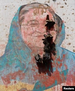 View of a mural of Bangladesh Prime Minister Sheikh Hasina vandalised by protesters, a day after her resignation, in Dhaka, Bangladesh, Aug. 6, 2024.