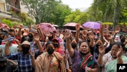 Myanmar refugees living in Delhi pray outside UNHCR office on the occasion of World Refugee Day in New Delhi, India, June 20, 2023.