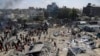 FILE - Palestinians inspect the damage at a site hit by an Israeli bombardment on Khan Younis, southern Gaza Strip, July 13, 2024. The attack reportedly killed Hamas Military Wing Commander Mohammed Deif.