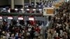 Air Asia passengers queue at counters inside Don Mueang International Airport Terminal 1 amid system outages disrupting the airline's operations, in Bangkok, Thailand, July 19, 2024. 