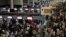 Air Asia passengers queue at counters inside Don Mueang International Airport Terminal 1 amid system outages disrupting the airline's operations, in Bangkok, Thailand, July 19, 2024. 
