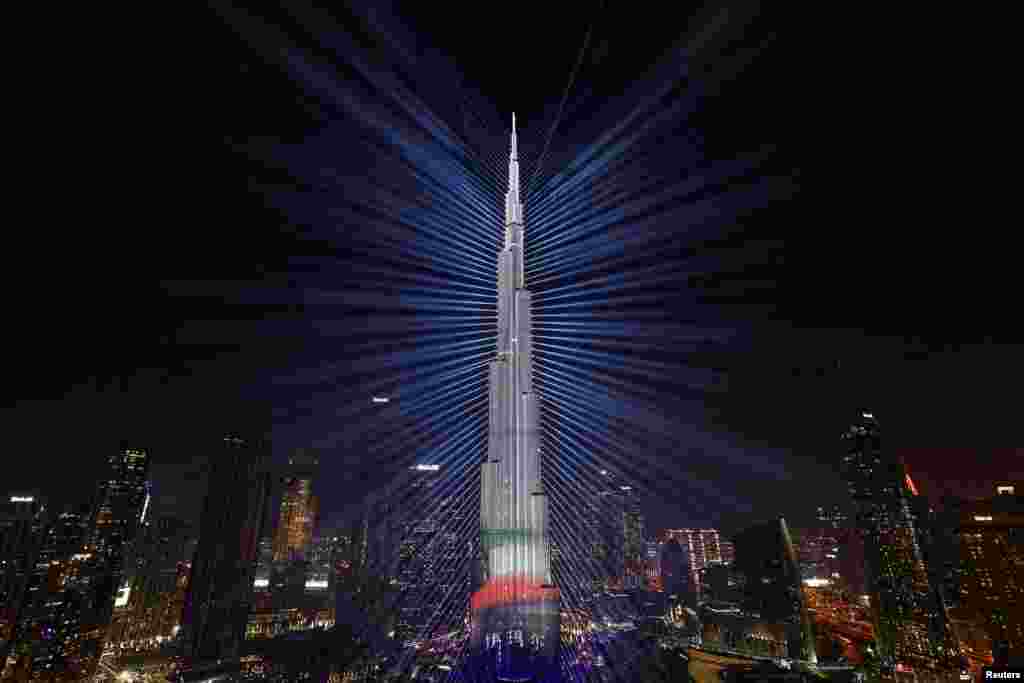 The colors of the United Arab Emirates flag are projected onto the Burj Khalifa, the tallest building in the world, during New Year's Eve celebrations in Dubai, United Arab Emirates, Dec. 31, 2023. 