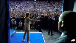 Democratic presidential nominee Vice President Kamala Harris is introduced by running mate Minnesota Gov. Tim Walz at a campaign rally at Desert Diamond Arena, Aug. 9, 2024, in Glendale, Ariz.