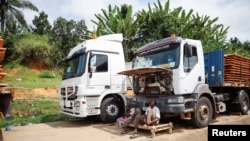 Truckers wait near their trucks because of the closure of the border after the coup in Gabon, in the border town of Kye-Ossi, Cameroon, Aug. 31, 2023. Gabon's army said on Sept. 2, 2023, that it would reopen the country's borders.