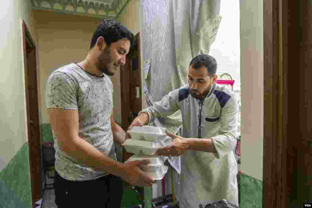 Ahmed, who manages a foundation that supports low-income college students, says, “Our budget can only afford half the meat this year. We’re torn between giving meat to half the students or half a portion to all of them.” (Hamada Elrasam/VOA) 