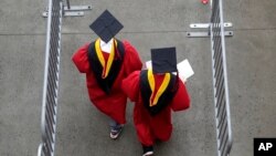 FILE - Graduates walk into High Point Solutions Stadium before the start of the Rutgers University graduation ceremony in Piscataway Township, NJ, May 13, 2018. 