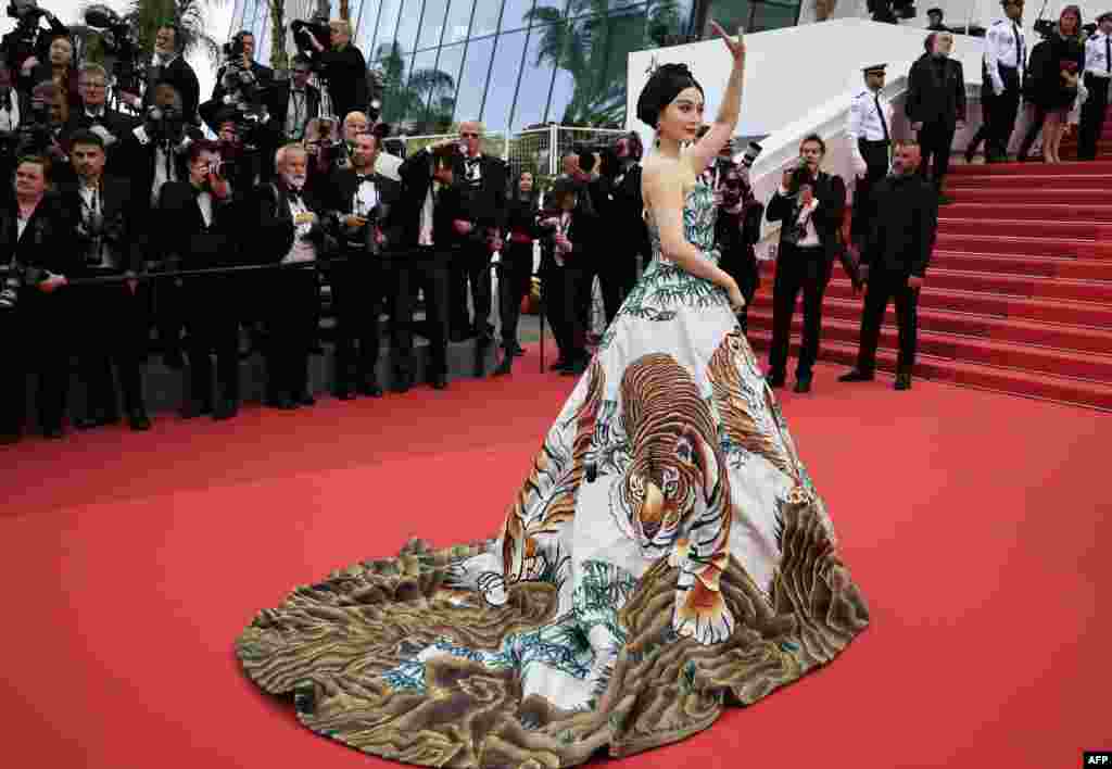 Chinese actress Fan Bingbing waves as she arrives for the screening of the film &quot;Jeanne Du Barry&quot; during the 76th edition of the Cannes Film Festival in Cannes, southern France.