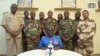 FILE - In this image taken from video provided by ORTN, Col. Maj. Amadou Abdramane, front center, makes a statement on July 26, 2023, in Niamey, Niger, as a delegation of military officers appeared on Niger State TV to announce their coup.
