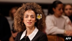 FILE - The United States has charged a senior Iranian official and three others linked to Tehran for their role in a failed assassination plot targeting VOA host Masih Alinejad, seen here at the Munich Security Conference in Munich, Germany, Feb. 18, 2023.