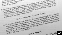 The affidavit in support of an arrest warrant for 16 fake Republican electors for Donald Trump in the 2020 presidential election in Michigan is photographed, July 18, 2023. 