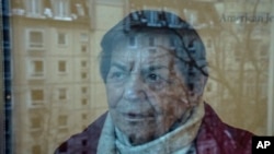 95-year-old Ruth Winkelmann, who is one of the survivors of the Holocaust, looks out of a window in Berlin, Germany, Wednesday, Jan. 17, 2024. (AP Photo/Ebrahim Noroozi)