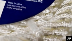 FILE - Synthetic rope, with labeling indicating it was made in China, is displayed in a store in Cranberry Township, Pa. May 9, 2019. President Joe Biden is still reviewing whether he wants to maintain tariffs on certain Chinese imports.